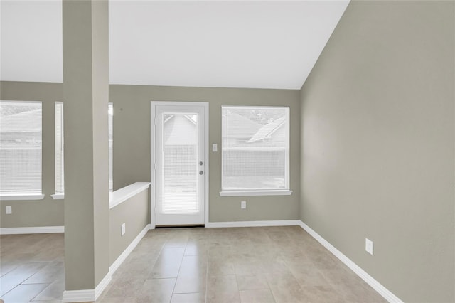 tiled entryway with vaulted ceiling