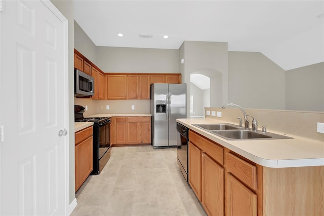 kitchen featuring sink, black appliances, and a kitchen island with sink