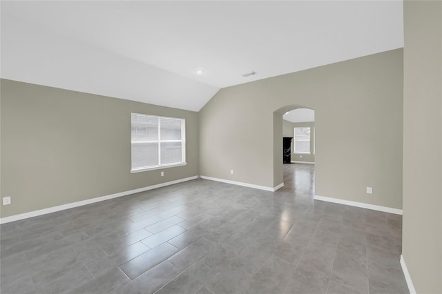 spare room with vaulted ceiling