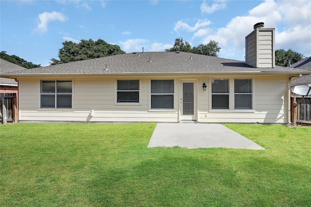 back of property with a yard and a patio area