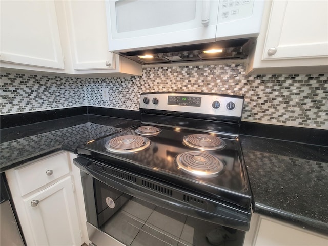 details with electric stove, decorative backsplash, and white cabinets