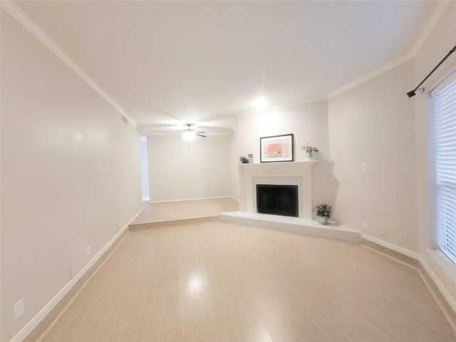 unfurnished living room with light hardwood / wood-style flooring, ceiling fan, and crown molding