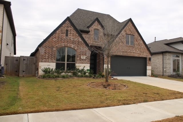 tudor home featuring a front yard