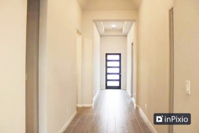 corridor featuring hardwood / wood-style floors and a raised ceiling