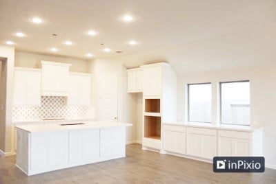 kitchen with light hardwood / wood-style floors, white cabinetry, tasteful backsplash, and a kitchen island