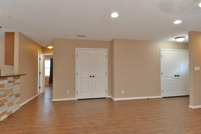 809 Pecan St, Brenham, TX 77833 - spare room featuring wood finished floors, baseboards, and recessed lighting