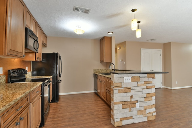 kitchen with a textured ceiling, dark hardwood / wood-style floors, black appliances, pendant lighting, and sink