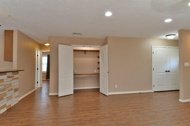 809 Pecan St, Brenham, TX 77833 - empty room with wood finished floors, baseboards, and recessed lighting