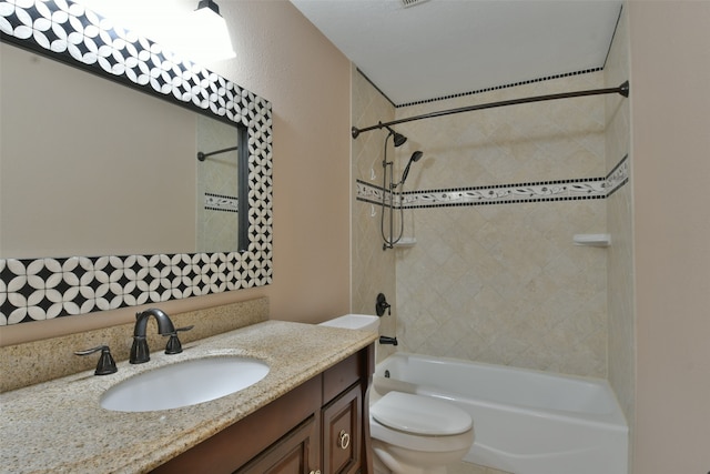 full bathroom with vanity, tiled shower / bath combo, and toilet