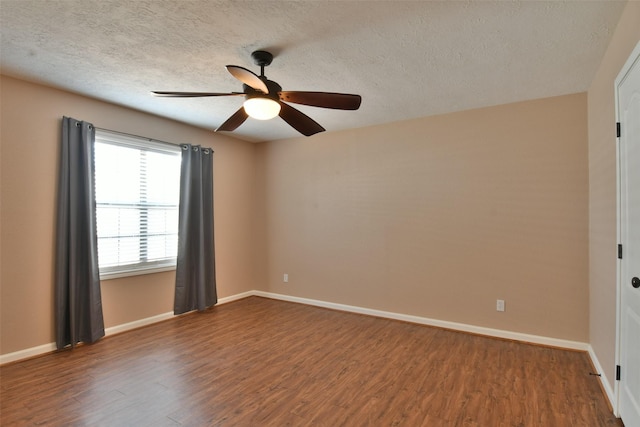 809 Pecan St, Brenham, TX 77833 - empty room featuring wood finished floors, a ceiling fan, baseboards, and a textured ceiling
