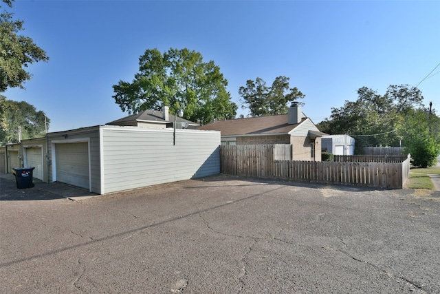 view of side of home with an outdoor structure and a garage