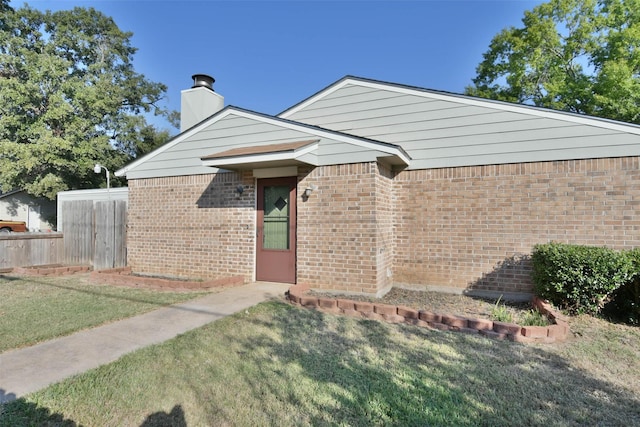 809 Pecan St, Brenham, TX 77833 - view of front of home with brick siding and a chimney