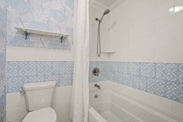 bathroom with toilet, tile walls, and shower / tub combo