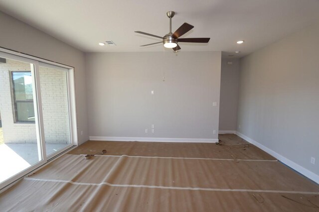 unfurnished room featuring ceiling fan and a wealth of natural light