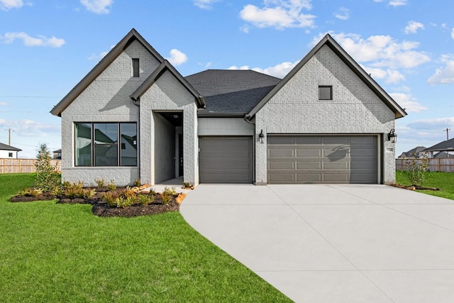 view of front of house with a garage and a front lawn