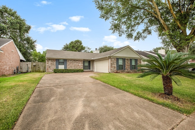 ranch-style house featuring a front lawn and a garage