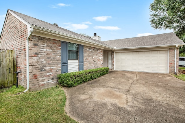 view of front of home with a garage and a front lawn