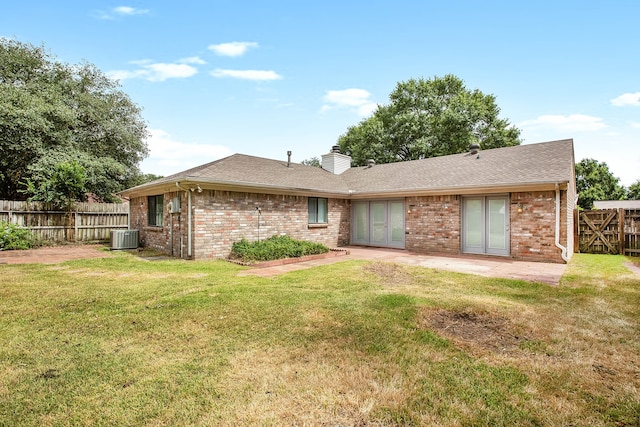 back of property featuring a patio area, a lawn, and cooling unit