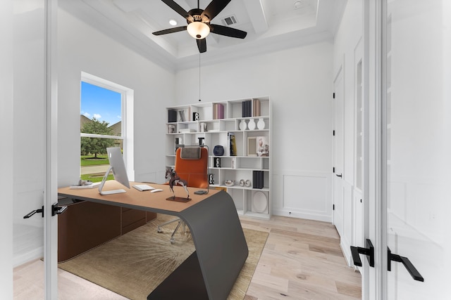 office area featuring beam ceiling, ceiling fan, light wood-type flooring, crown molding, and french doors