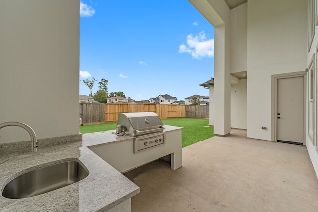 view of patio featuring sink and a grill