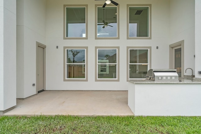 exterior space with sink, a patio area, and an outdoor kitchen