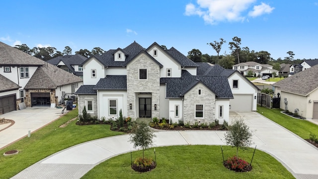 french country style house with a front yard and a garage