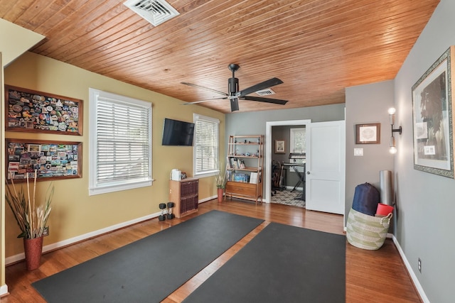 workout area featuring dark wood-type flooring and ceiling fan