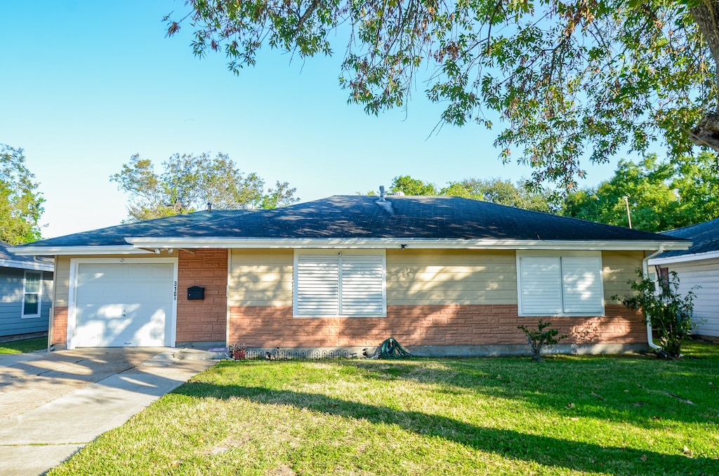 ranch-style house with a front yard and a garage