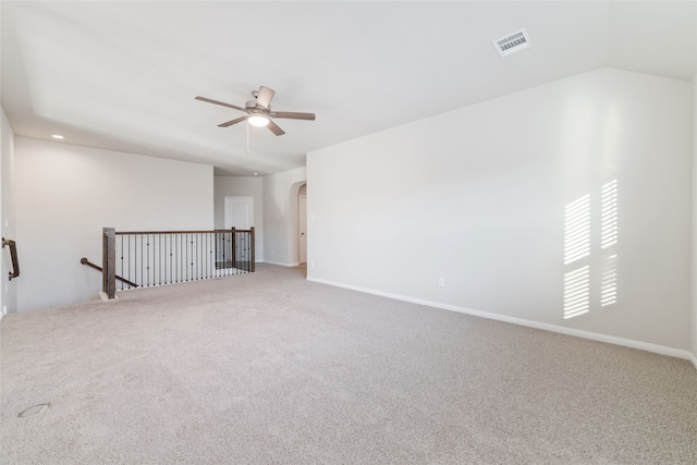 carpeted empty room with ceiling fan and vaulted ceiling