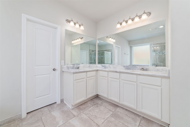 bathroom featuring vanity, an enclosed shower, and tile patterned floors