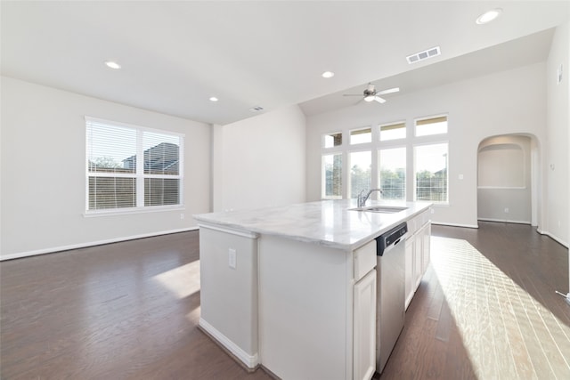 kitchen with a healthy amount of sunlight, dark hardwood / wood-style flooring, a center island with sink, and dishwasher