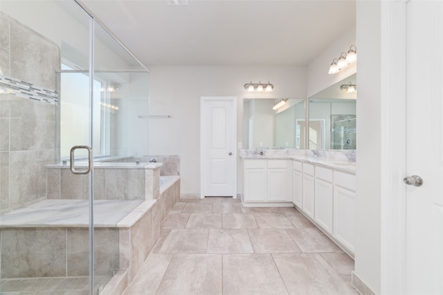 bathroom with vanity, shower with separate bathtub, and tile patterned floors