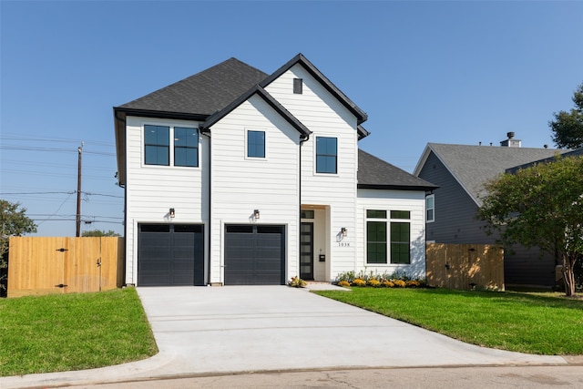 view of front of home featuring a garage and a front lawn