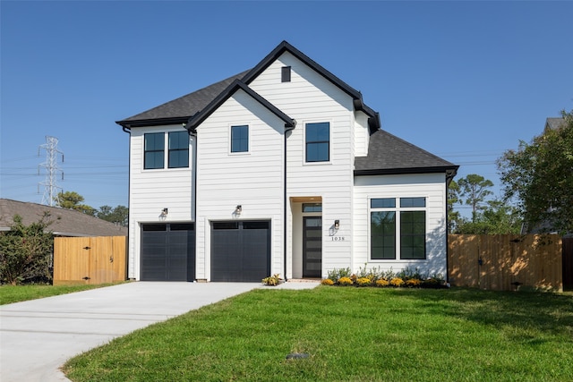 view of front facade with a front yard and a garage