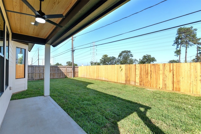 view of yard with a patio and ceiling fan