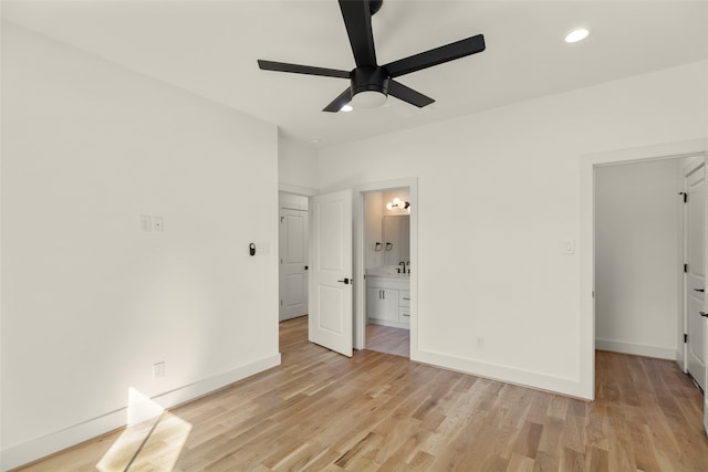 unfurnished bedroom with ceiling fan, ensuite bath, and light hardwood / wood-style floors