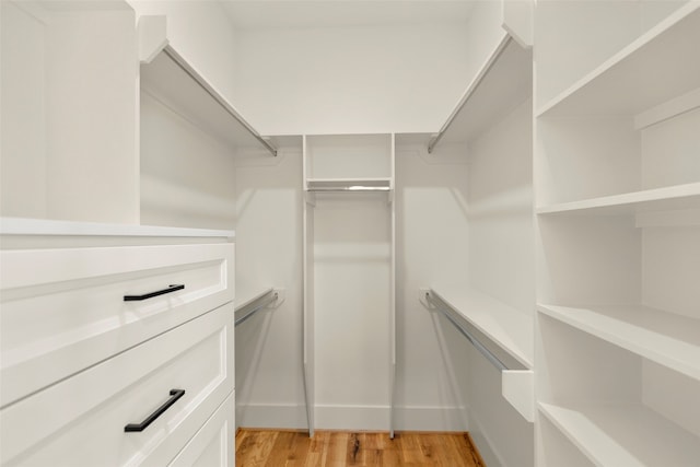 walk in closet featuring light hardwood / wood-style flooring