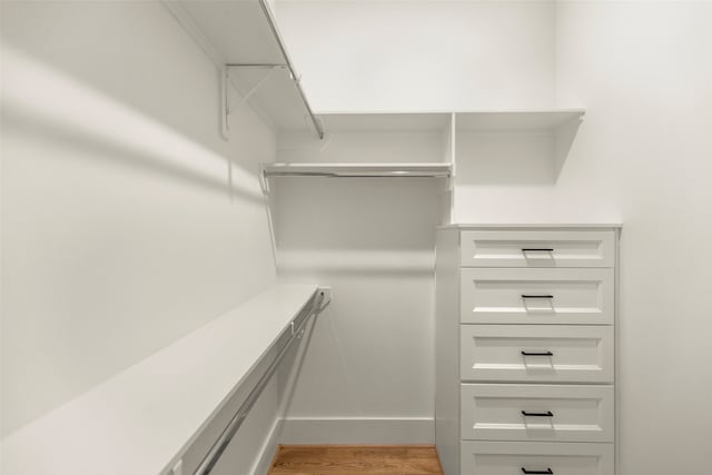 walk in closet featuring light hardwood / wood-style flooring