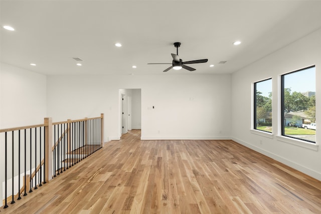 empty room featuring light hardwood / wood-style flooring and ceiling fan