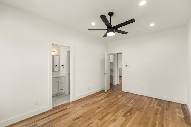 unfurnished bedroom featuring connected bathroom, ceiling fan, and light hardwood / wood-style flooring