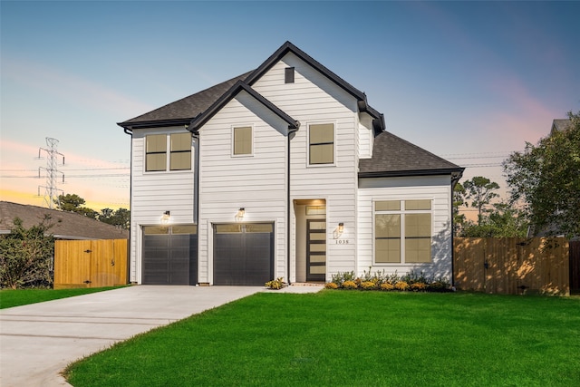 view of front of home featuring a lawn and a garage