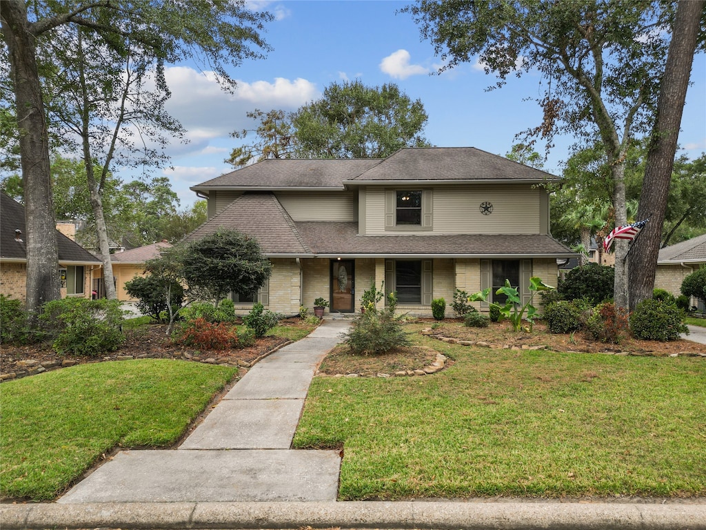 view of front of house with a porch and a front yard