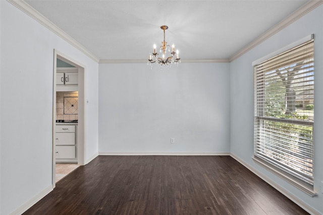 spare room featuring crown molding, dark hardwood / wood-style floors, and an inviting chandelier