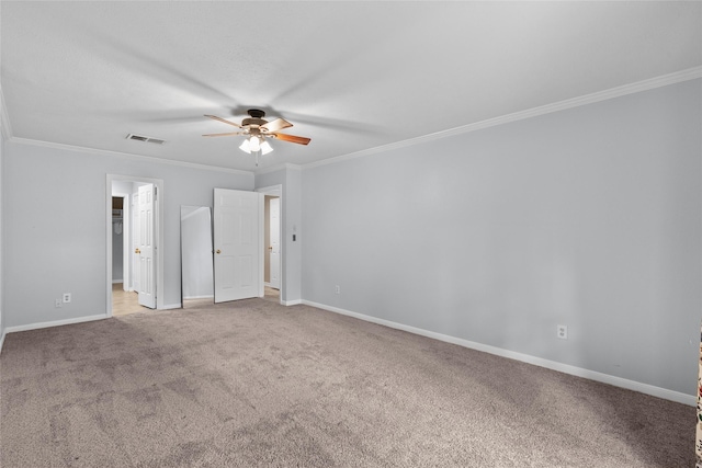 carpeted spare room with ceiling fan and ornamental molding