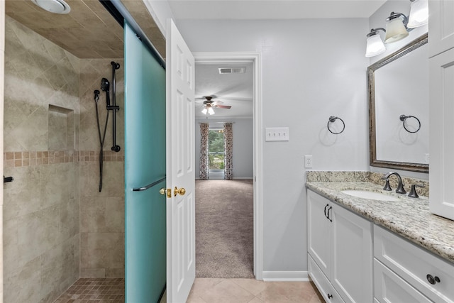 bathroom featuring vanity, tiled shower, and tile patterned floors