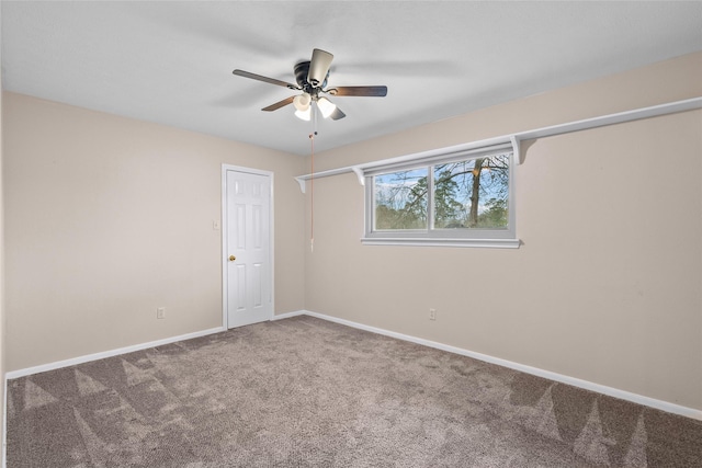 carpeted spare room with ceiling fan