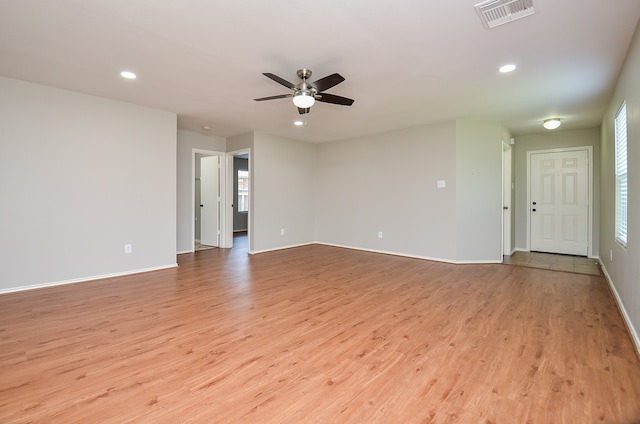 spare room featuring ceiling fan, light wood-style flooring, recessed lighting, baseboards, and visible vents