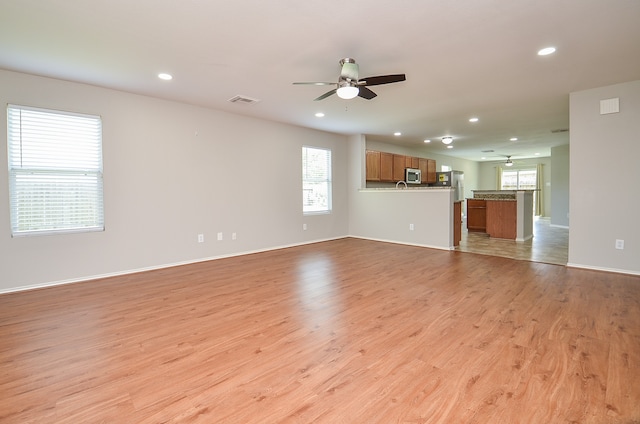 unfurnished living room featuring recessed lighting, light wood-style floors, and ceiling fan