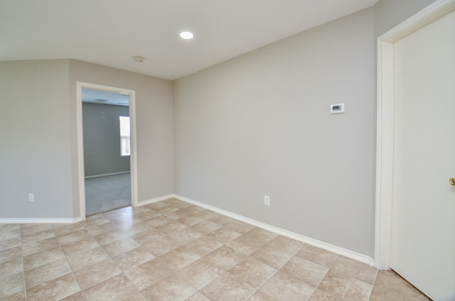 empty room with recessed lighting, baseboards, and light tile patterned floors