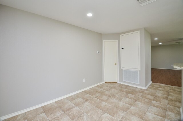 empty room with recessed lighting, baseboards, and visible vents